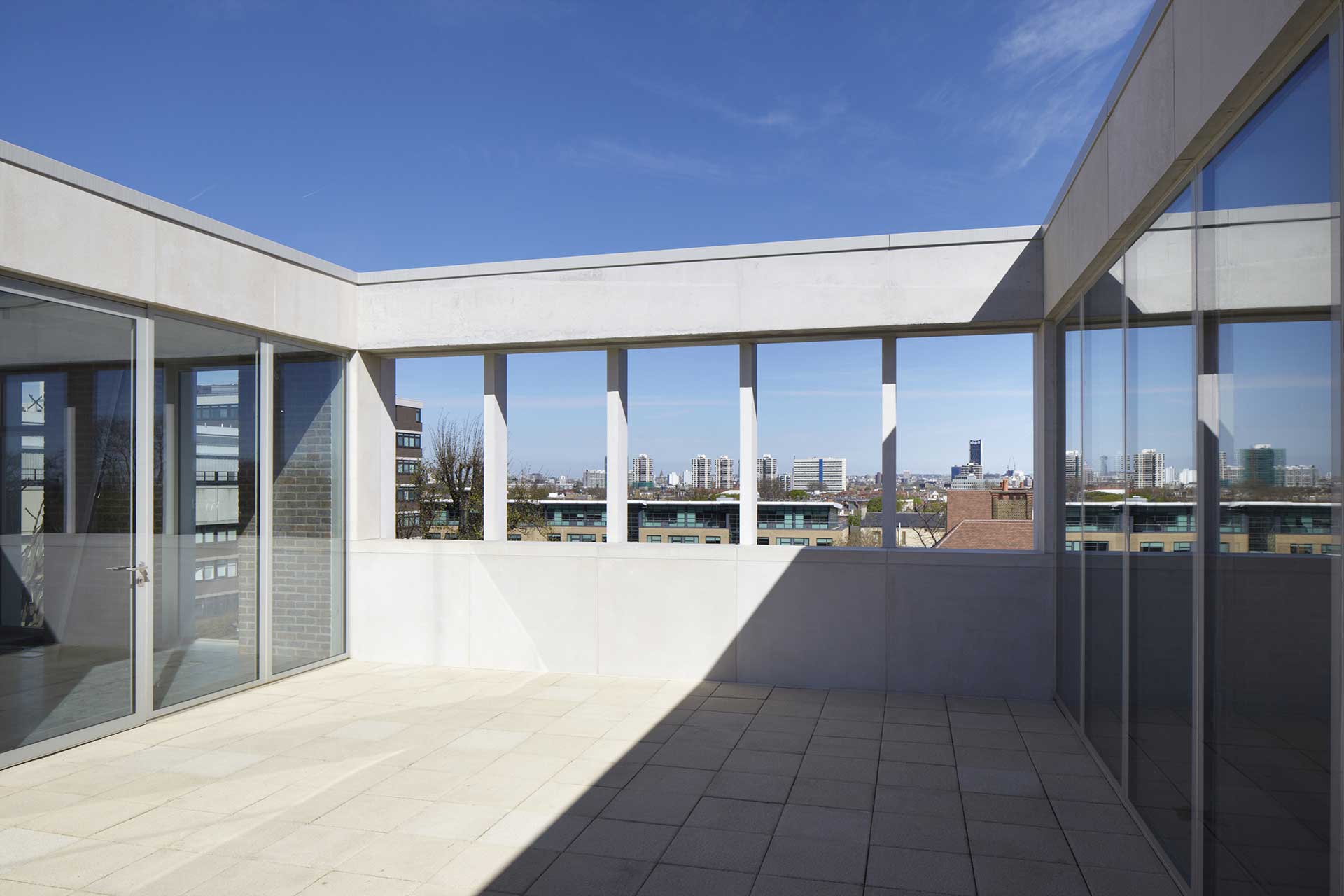 Roof terrace in partial shade against a blue sky