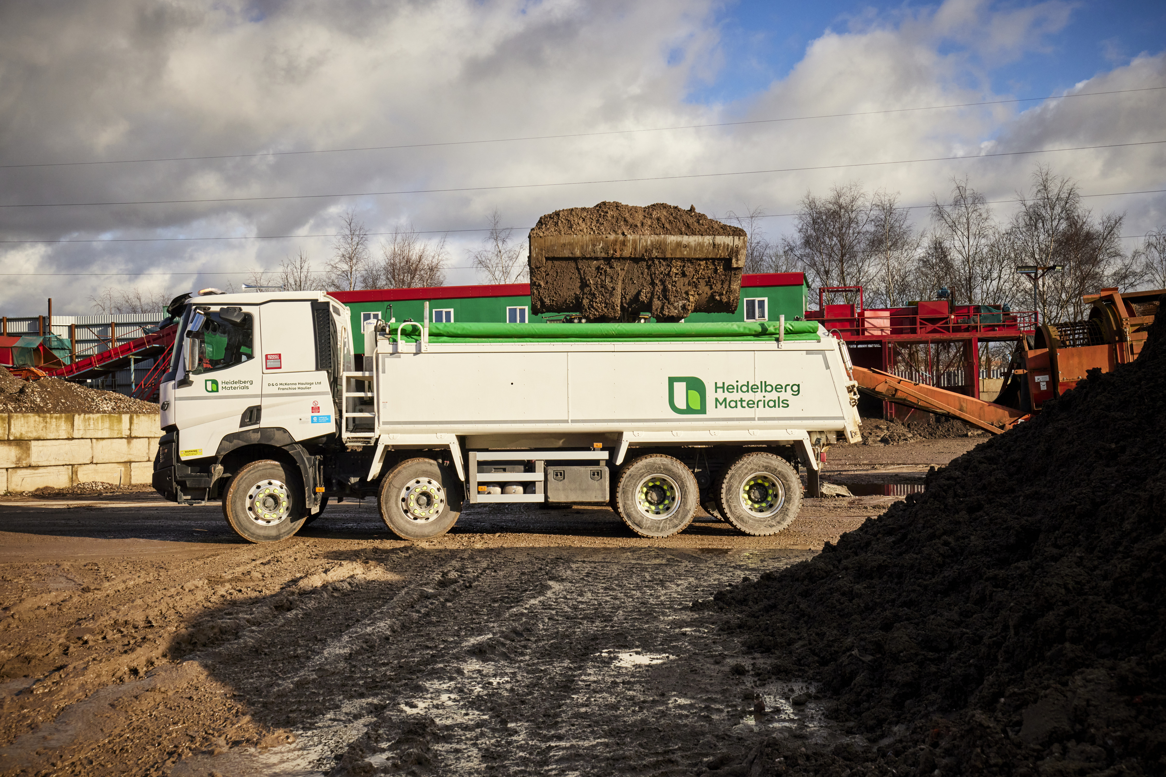 A Heidelberg Materials truck is parked at an industrial site.