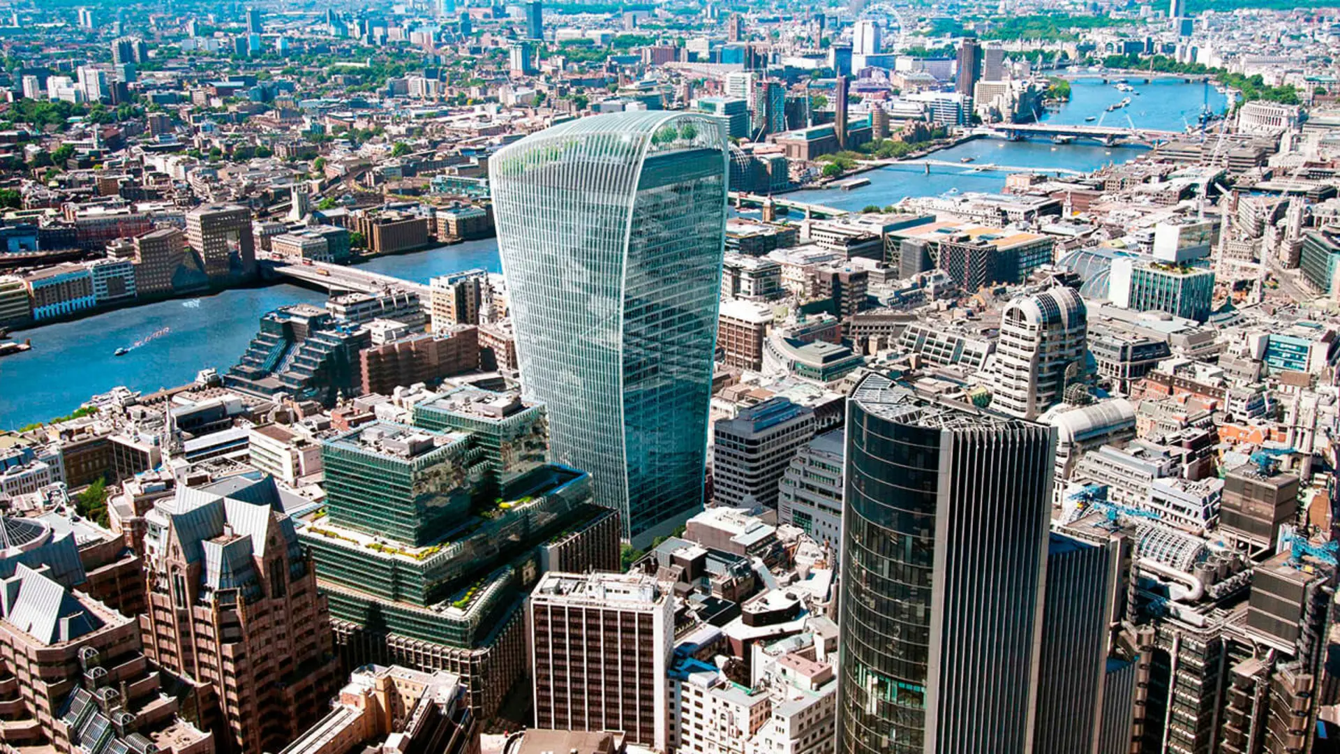 Aerial view of central London featuring the Walkie Talkie building, the River Thames, and surrounding skyscrapers.