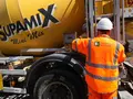 Supamix concrete truck with Heidelberg Materials employee wearing full PPE